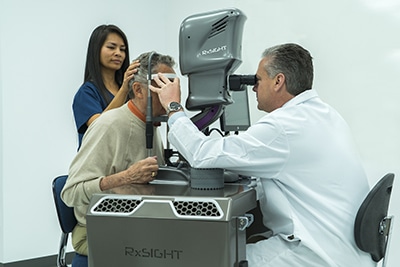 Doctor using Light Delivery Device for Light Adjustable Lens