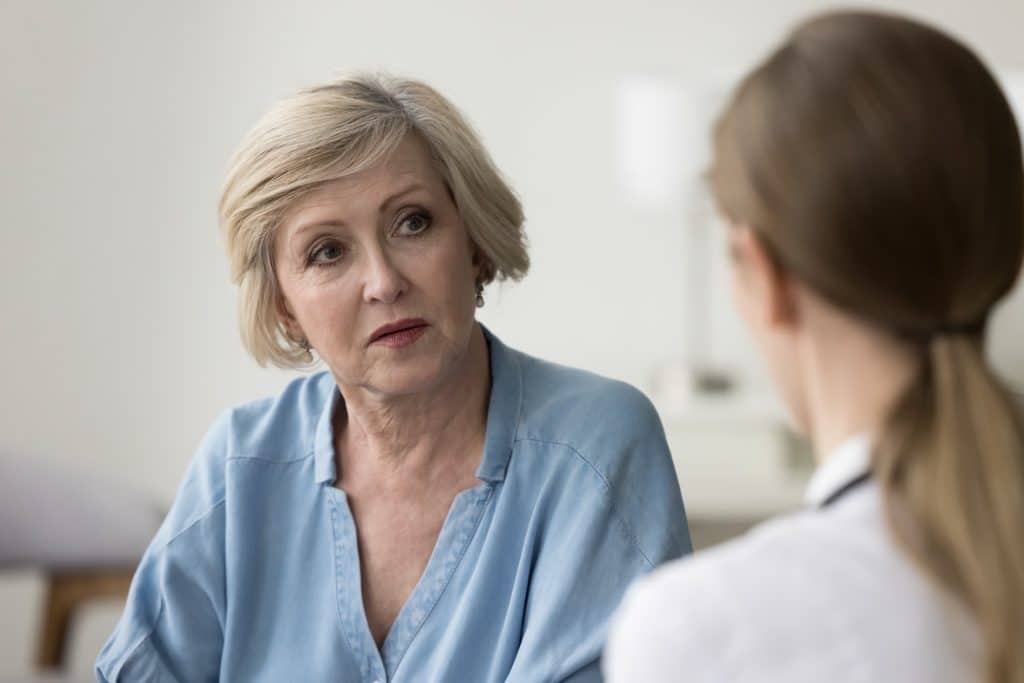 Senior woman listening during a doctor consultation