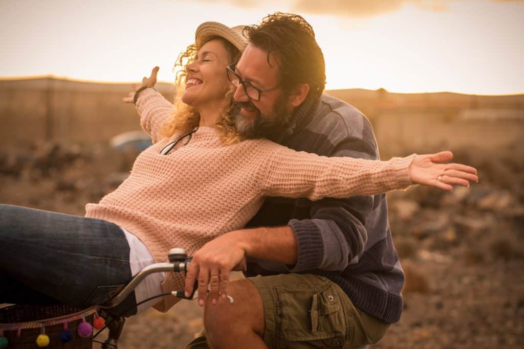 Joyful couple outdoors at sunset