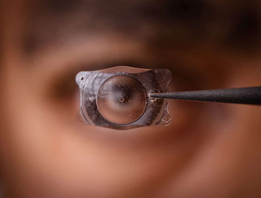 Close-up of an artificial lens implant in front of an eye